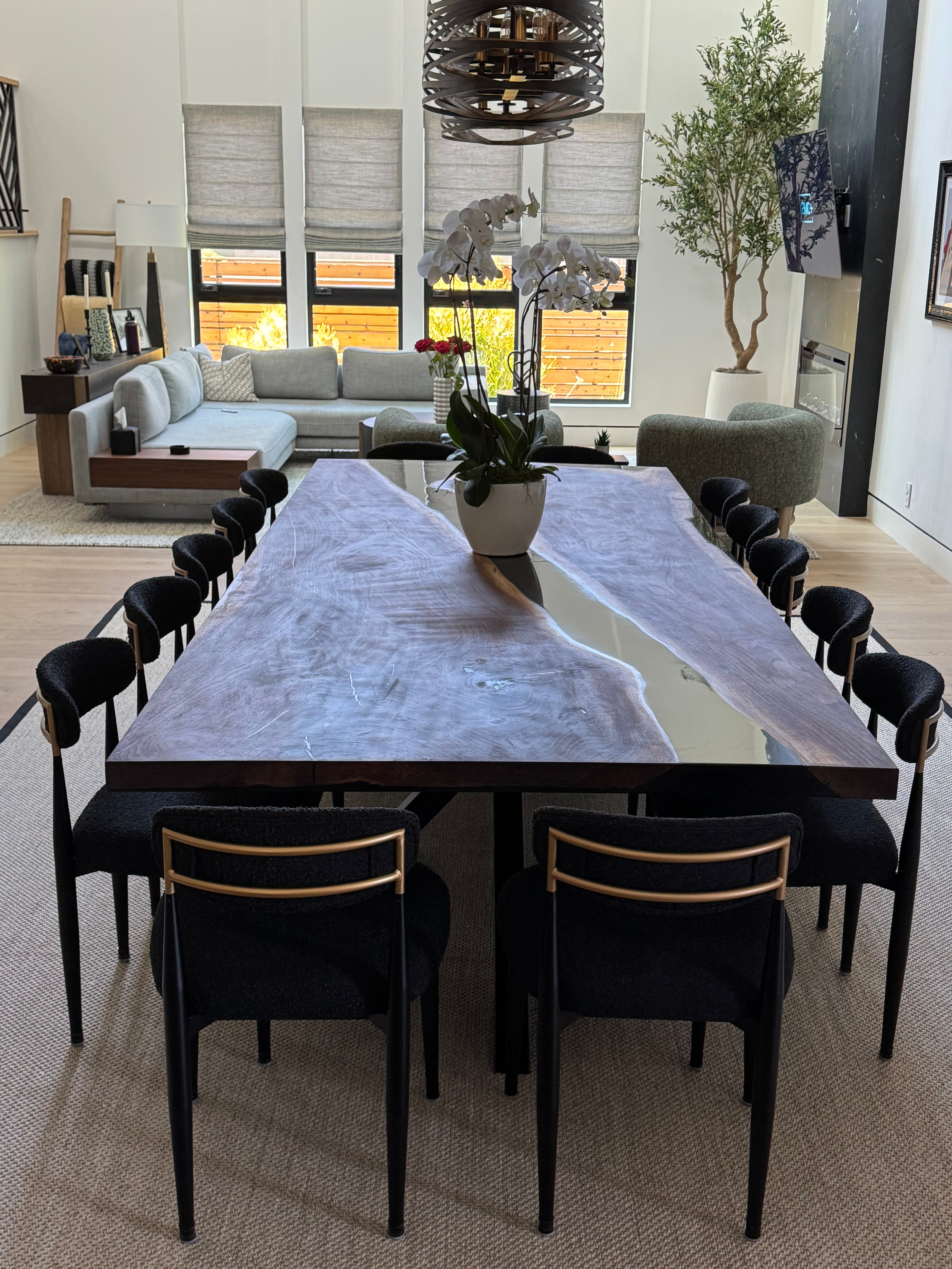 Luxurious walnut dining table with central diagonal black epoxy river set in customer home.