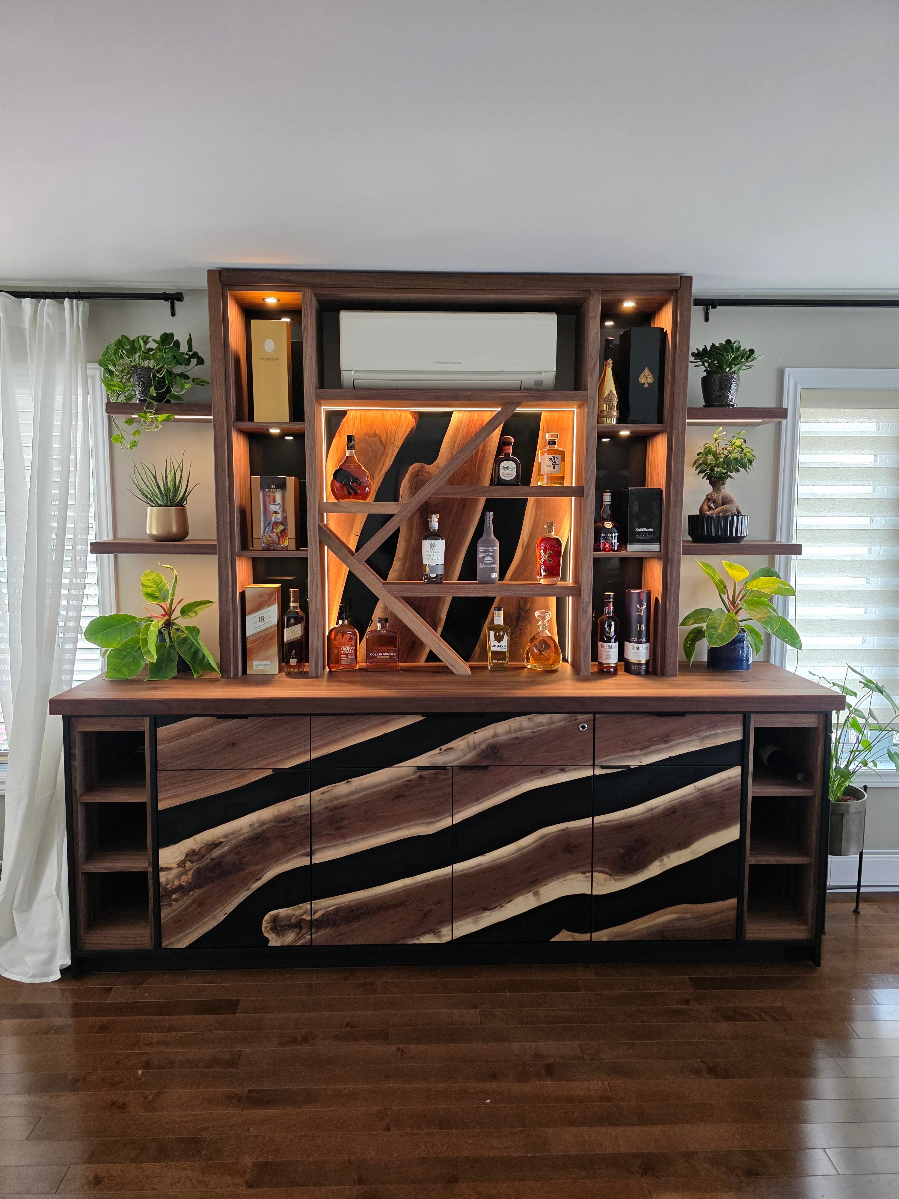 Wooden entertainment console with walnut and epoxy LED-lit shelves and drawers in a room setting.